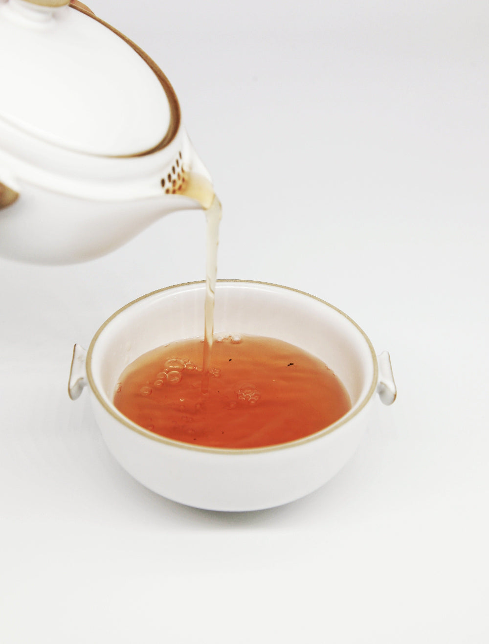 teapot and cup pouring tea