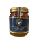 Jar of Waveney Valley Honey with a gold lid in a glass glass