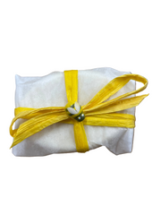 Goat milk soap with oats and honey wrapped in parchment paper