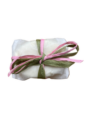 Goats milk soap with cherry blossom wrapped in parchment paper