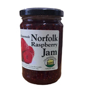 Jar of Norfolk Raspberry Jam with a label on a white background